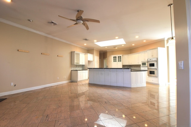 11 Pheasant Ridge Rd, Newtown, CT 06470 - kitchen featuring dark countertops, white double oven, ornamental molding, a ceiling fan, and backsplash