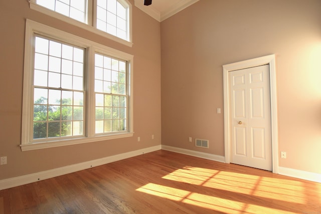 11 Pheasant Ridge Rd, Newtown, CT 06470 - empty room featuring plenty of natural light, ornamental molding, wood finished floors, a high ceiling, and a ceiling fan