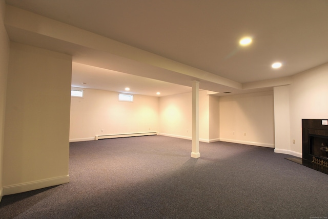 11 Pheasant Ridge Rd, Newtown, CT 06470 - basement with a baseboard heating unit, recessed lighting, dark carpet, and a fireplace with raised hearth