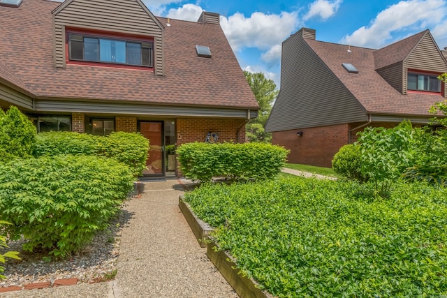 30 Montoya Dr Unit 30, Branford, CT 06405 - view of front facade featuring brick siding, a chimney, and roof with shingles
