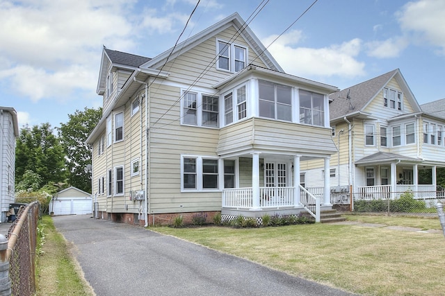 100 Union Ave, West Haven, CT 06516 - view of front of house with covered porch, a detached garage, and an outbuilding