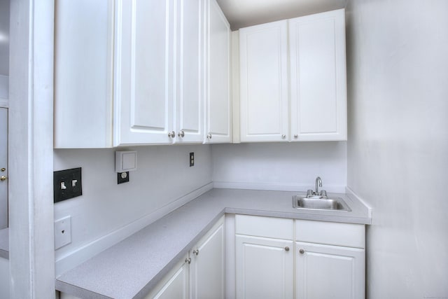 100 Union Ave, West Haven, CT 06516 - kitchen featuring a sink, white cabinetry, and light countertops