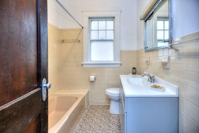 100 Union Ave, West Haven, CT 06516 - full bath featuring tile walls, vanity, toilet, a wainscoted wall, and washtub / shower combination