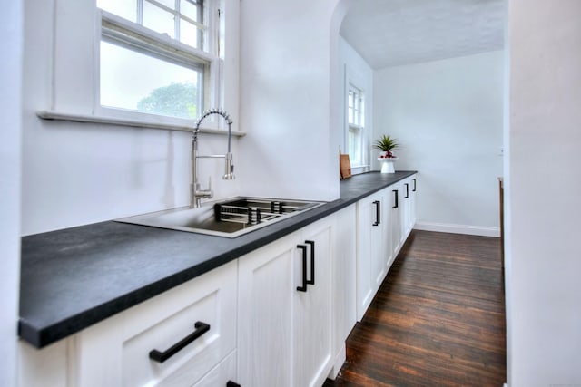 100 Union Ave, West Haven, CT 06516 - kitchen with a sink, dark countertops, dark wood finished floors, and white cabinetry