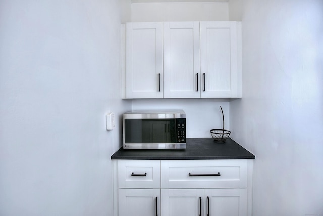 100 Union Ave, West Haven, CT 06516 - detailed view of stainless steel microwave, white cabinetry, and dark countertops