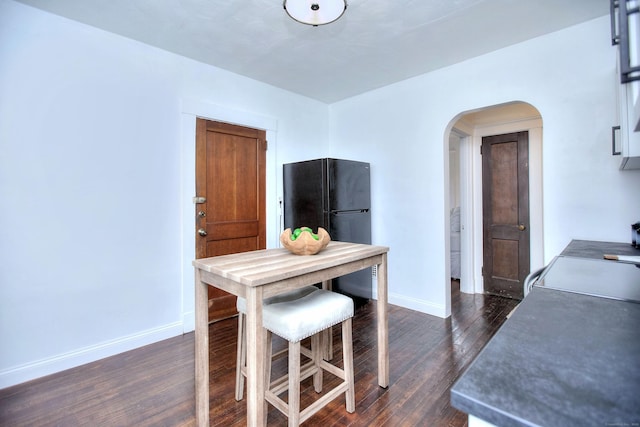 100 Union Ave, West Haven, CT 06516 - dining room with arched walkways, baseboards, and dark wood finished floors