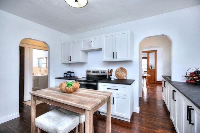 100 Union Ave, West Haven, CT 06516 - kitchen with stainless steel electric range oven, arched walkways, and dark countertops