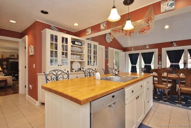 2 Tamshell Dr, Kent, CT 06757 - kitchen featuring dishwasher, light tile patterned flooring, a sink, white cabinetry, and vaulted ceiling