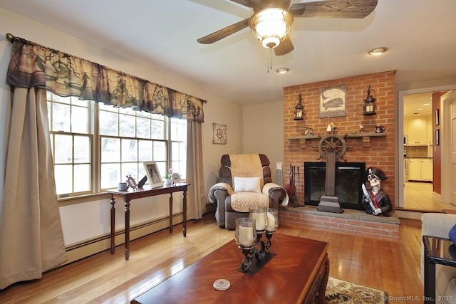 2 Tamshell Dr, Kent, CT 06757 - living area with baseboard heating, wood finished floors, a fireplace, a ceiling fan, and recessed lighting