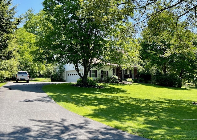 2 Tamshell Dr, Kent, CT 06757 - view of property hidden behind natural elements with driveway, a front yard, and a garage