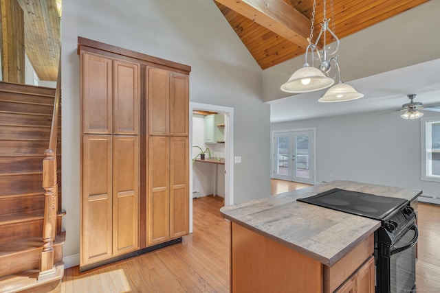 23 Ross Rd, Preston, CT 06365 - kitchen with black range with electric stovetop, a kitchen island, wooden ceiling with exposed beams, light wood finished floors, and french doors