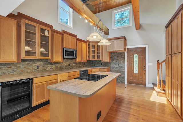 23 Ross Rd, Preston, CT 06365 - kitchen featuring beverage cooler, stainless steel microwave, a high ceiling, decorative backsplash, and light wood-style flooring
