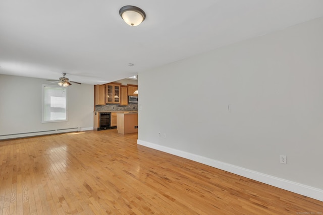 23 Ross Rd, Preston, CT 06365 - unfurnished living room with beverage cooler, a baseboard heating unit, light wood finished floors, baseboards, and ceiling fan