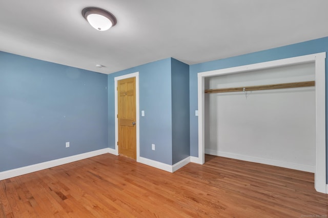 23 Ross Rd, Preston, CT 06365 - unfurnished bedroom with baseboards, a closet, and light wood-type flooring