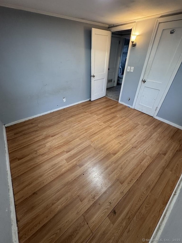 1 Stoughton Rd, Southington, CT 06489 - unfurnished bedroom featuring light wood finished floors, baseboards, and crown molding