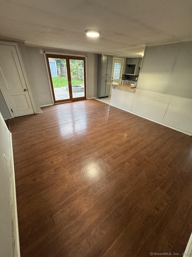 1 Stoughton Rd, Southington, CT 06489 - unfurnished living room with dark wood-style floors and wainscoting