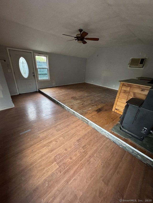 1 Stoughton Rd, Southington, CT 06489 - unfurnished living room with lofted ceiling, a wood stove, hardwood / wood-style floors, a ceiling fan, and baseboards