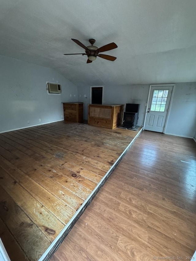 1 Stoughton Rd, Southington, CT 06489 - unfurnished living room featuring vaulted ceiling, ceiling fan, wood finished floors, a wall mounted AC, and baseboards