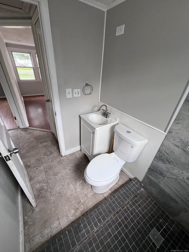 1 Stoughton Rd, Southington, CT 06489 - bathroom featuring toilet, vanity, tile walls, and baseboards