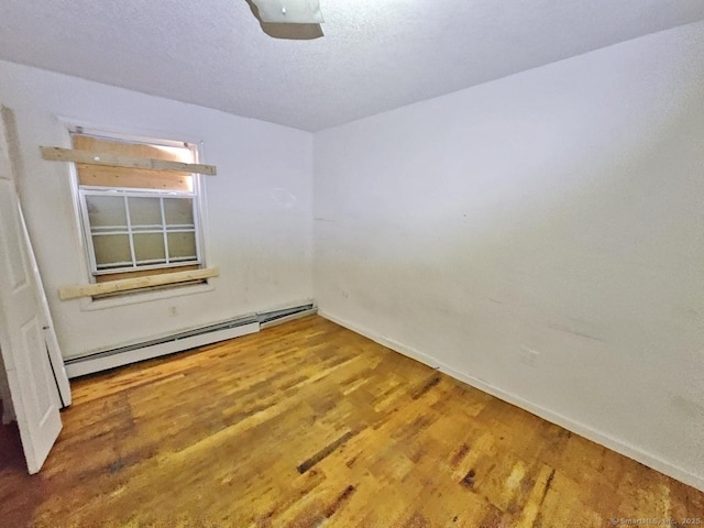 270 Capen St, Hartford, CT 06112 - unfurnished room featuring wood finished floors, baseboards, a baseboard heating unit, and a textured ceiling