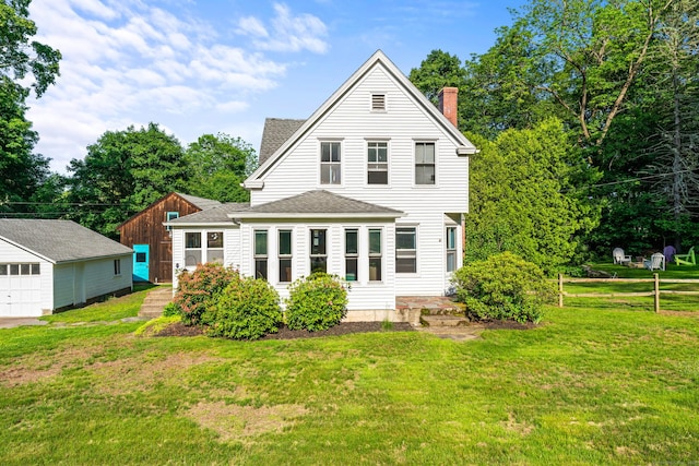 5 Maple Corners Rd, Ledyard, CT 06335 - back of property featuring a chimney, roof with shingles, a lawn, and an outdoor structure