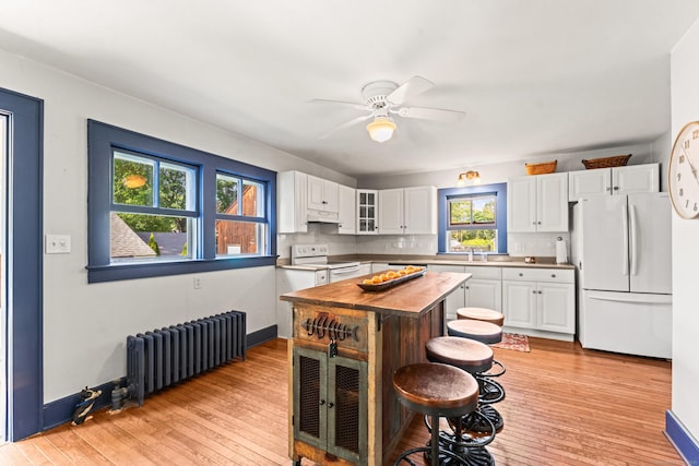 5 Maple Corners Rd, Ledyard, CT 06335 - kitchen featuring white appliances, radiator, white cabinets, and glass insert cabinets