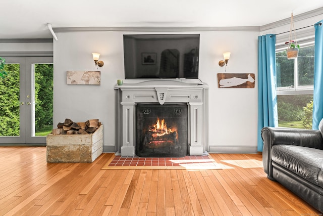 5 Maple Corners Rd, Ledyard, CT 06335 - living area with ornamental molding, light wood finished floors, french doors, and a fireplace with flush hearth