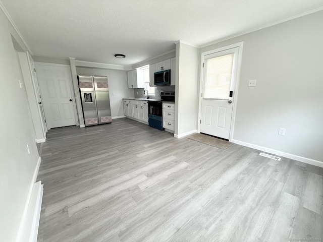 40 Cherry St, Hartford, CT 06106 - kitchen featuring electric range oven, stainless steel fridge with ice dispenser, black microwave, ornamental molding, and light wood-style flooring