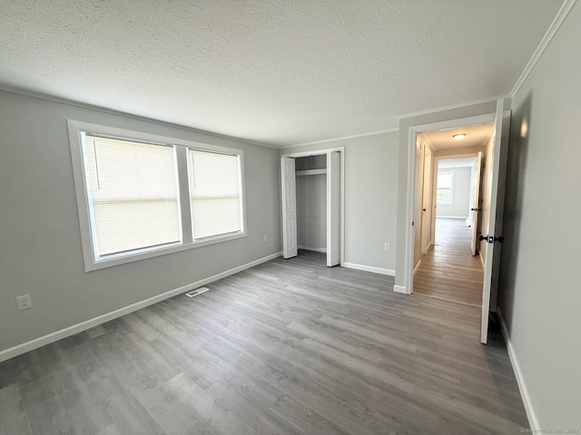 40 Cherry St, Hartford, CT 06106 - unfurnished bedroom with wood finished floors, a textured ceiling, and a closet