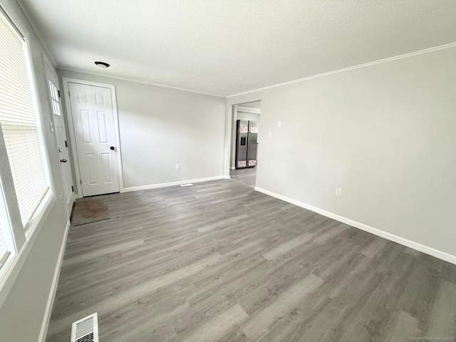 40 Cherry St, Hartford, CT 06106 - spare room with wood finished floors, ornamental molding, and a textured ceiling