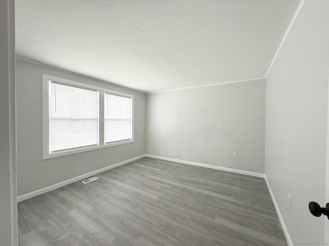 40 Cherry St, Hartford, CT 06106 - empty room featuring dark wood-style flooring, a textured ceiling, and ornamental molding