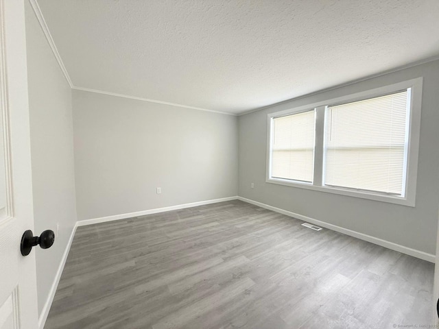 40 Cherry St, Hartford, CT 06106 - spare room featuring wood finished floors, crown molding, and a textured ceiling