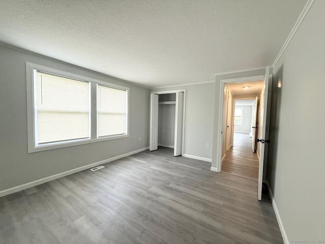 40 Cherry St, Hartford, CT 06106 - unfurnished bedroom with wood finished floors, a textured ceiling, a closet, and crown molding