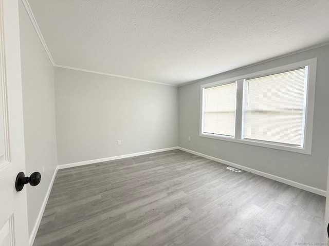 40 Cherry St, Hartford, CT 06106 - spare room featuring wood finished floors, ornamental molding, and a textured ceiling
