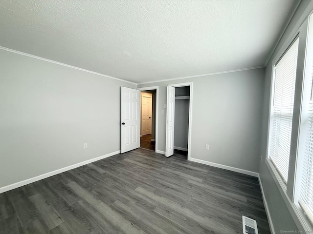 40 Cherry St, Hartford, CT 06106 - unfurnished bedroom with a textured ceiling, dark wood-style flooring, a closet, and ornamental molding