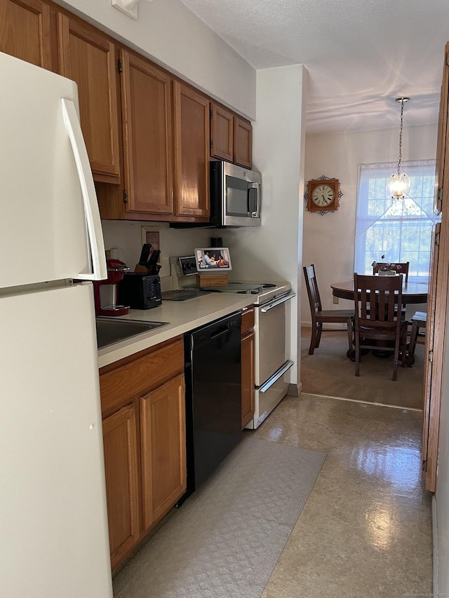 268 Hartford Tpke Apt A2, Tolland, CT 06084 - kitchen featuring freestanding refrigerator, black dishwasher, stainless steel microwave, brown cabinets, and range