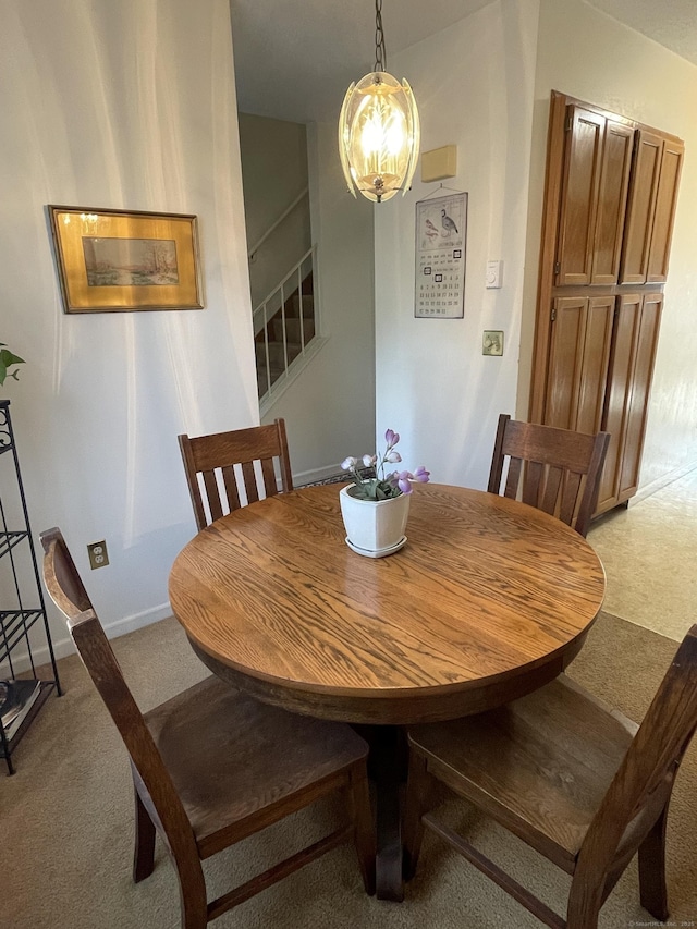 268 Hartford Tpke Apt A2, Tolland, CT 06084 - dining space with light colored carpet, stairs, a chandelier, and baseboards