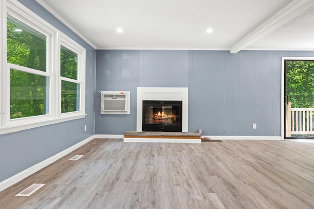 157 Mile Creek Rd, Old Lyme, CT 06371 - unfurnished living room featuring an AC wall unit, wood finished floors, a glass covered fireplace, crown molding, and recessed lighting