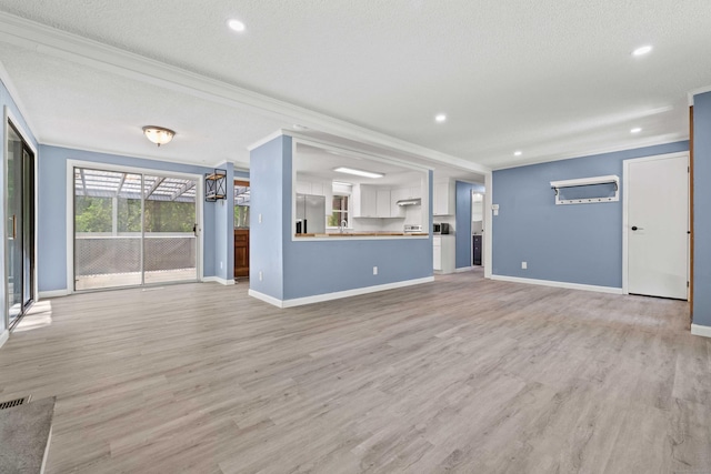 157 Mile Creek Rd, Old Lyme, CT 06371 - unfurnished living room featuring ornamental molding, light wood finished floors, recessed lighting, and a textured ceiling