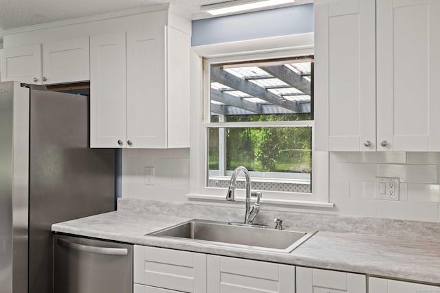 157 Mile Creek Rd, Old Lyme, CT 06371 - kitchen featuring stainless steel appliances, white cabinets, light countertops, tasteful backsplash, and healthy amount of natural light