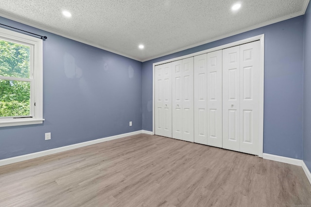 157 Mile Creek Rd, Old Lyme, CT 06371 - unfurnished bedroom featuring wood finished floors, a textured ceiling, recessed lighting, and a closet