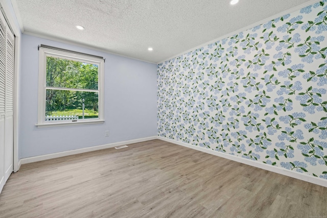 157 Mile Creek Rd, Old Lyme, CT 06371 - empty room featuring a textured ceiling, wood finished floors, ornamental molding, and recessed lighting