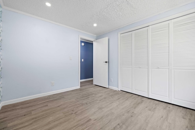 157 Mile Creek Rd, Old Lyme, CT 06371 - unfurnished bedroom featuring wood finished floors, ornamental molding, a textured ceiling, a closet, and recessed lighting