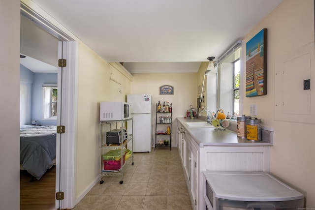 45 E St, Madison, CT 06443 - kitchen featuring white appliances, a sink, white cabinets, light countertops, and light tile patterned flooring