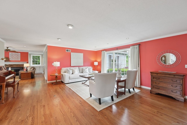 20 Cherry Ln, Madison, CT 06443 - living area with crown molding, light wood finished floors, baseboards, and a glass covered fireplace