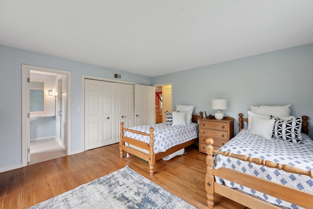 20 Cherry Ln, Madison, CT 06443 - bedroom featuring wood finished floors, baseboards, a closet, and ensuite bath