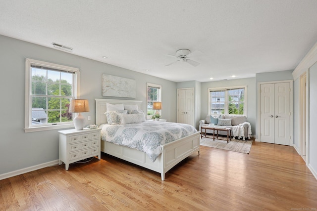 20 Cherry Ln, Madison, CT 06443 - bedroom featuring multiple closets, light wood-type flooring, multiple windows, baseboards, and recessed lighting