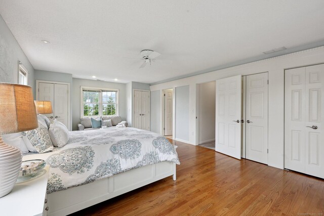 20 Cherry Ln, Madison, CT 06443 - bedroom with two closets, wood finished floors, and recessed lighting