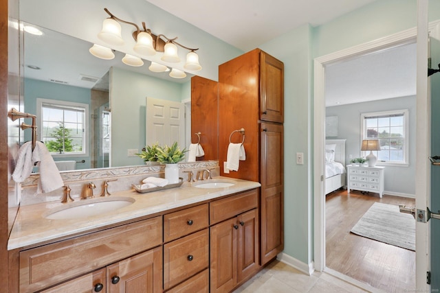 20 Cherry Ln, Madison, CT 06443 - full bathroom featuring double vanity, ensuite bath, a stall shower, and baseboards