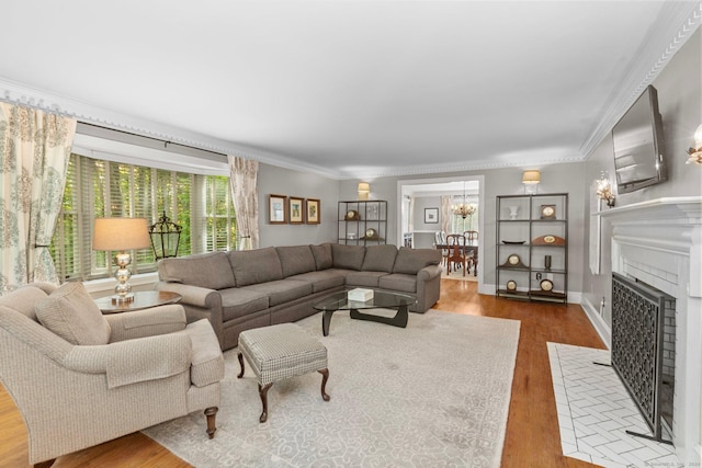 3 Dan Beard Ln, Redding, CT 06896 - living room with wood finished floors, crown molding, a chandelier, a fireplace with flush hearth, and baseboards